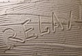 The word rest written in the sand by hand