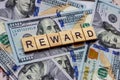 The word Reward on dollar usa background. Rewarding and financial bonus concept. Royalty Free Stock Photo