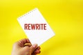 The word Rewrite on a notebook in a female hand