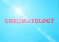 Word Rheumatology in red letters on a blue background. The concept of a section of medicine that treats inflammation and diseases