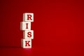 The word risk on wooden cubes. Risk and uncertainty in business and decision making strategy concept.