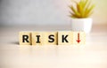 Word RISK. Wooden small cubes with letters on sunshine background with copy space available. Concept image