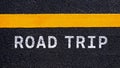 The word road trip on asphalt and yellow line road. Concept for travel