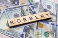 The word robbery on dollar usa background. Theft and stealing money concept.
