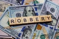 The word robbery on dollar usa background. Theft and stealing money concept.