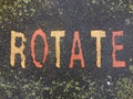 The word ROTATE on the floor in a kids park