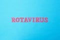 Word rotavirus made of red letters on a blue background. The concept of rotavirus infection in children and adults