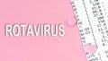 Word Rotavirus on pink background, medical concept, top view