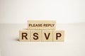 Word rsvp. Wooden small cubes with letters on the table