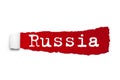 Word RUSSIA written under the curled piece of Red torn paper. Concept Image