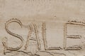 The word sale is painted on the sand. Beach background. View from above. The concept of summer, summer kanikkuly, vacation, Royalty Free Stock Photo