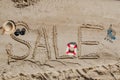 The word sale is painted on the sand. Beach background. View from above. The concept of summer, summer kanikkuly, vacation, Royalty Free Stock Photo