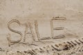 The word sale is painted on the sand. Beach background. View from above. The concept of summer, summer kanikkuly, vacation, Royalty Free Stock Photo