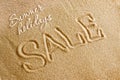 The word sale is painted on the sand and the inscription is a summer holiday. Beach background. View from above. The concept of Royalty Free Stock Photo