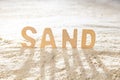 Word sand on a sandy surface