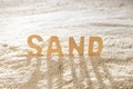 The word sand from wooden letters on the sand