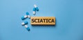 the word sciatica on wooden block. Medical concept