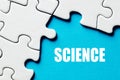 The word science surrounded by puzzle pieces. Education concept Royalty Free Stock Photo