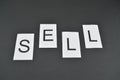Word Sell on black background. Letters of word SELL in promotion
