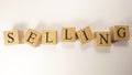 The word selling was created from wooden cubes. Economy and Shopping. Close up. Royalty Free Stock Photo