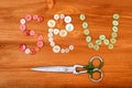 Word sew from multicolored sewing buttons and scissors on wooden background Royalty Free Stock Photo