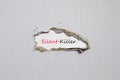 The word silent killer appearing behind torn paper