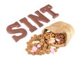 Word SINT and bag of ginger nuts and sweets for Dutch event Sinterklaas Royalty Free Stock Photo