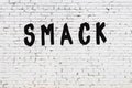 Word smack painted on white brick wall