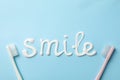 Word Smile made of toothpaste on background, top view