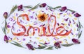 The word Smile spelled out with flowers.