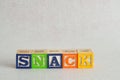 The word snack spelled with colorful alphabet blocks Royalty Free Stock Photo