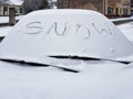 The word snow written on a snow-covered car window. Snow-covered cars in the winter. Cold weather. Dirty road traffic Royalty Free Stock Photo