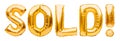 Word SOLD made of golden inflatable balloons isolated on white background. Helium balloons gold foil forming word, sold out banner Royalty Free Stock Photo