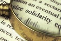 The word `solidarity` emphasized by a magnifying glass. Royalty Free Stock Photo