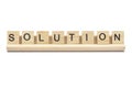 Word ``solution`` on scrabble wooden letters on a rack Royalty Free Stock Photo