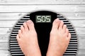 Word SOS written on a weight scale Royalty Free Stock Photo