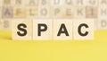 word spac is written on wooden cubes on a bright yellow surface, concept