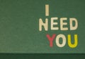 The word spelling to `I need you` on green background