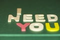 The word spelling to `I need you` on green background