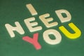 The word spelling to `I need you` on green background