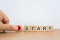 Word start on wooden cubes with blurred hand pressing the start button for make a new start or restart in life, business Royalty Free Stock Photo