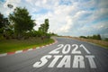 Word 2021 start written on road of racetrack straight to mountain. New year 2021 or start straight concept. Concept of planning