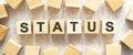 The word STATUS consists of wooden cubes with letters, top view on a light background Royalty Free Stock Photo
