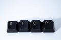 The word `STOP` written with keyboard keys