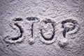 Word Stop written in white flour powder. Concepts of drug abuse as people turn to narcotics abuse during the hard times of covid Royalty Free Stock Photo
