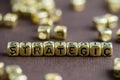 Word STRATEGIC made from small golden letters on the brown backg Royalty Free Stock Photo