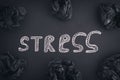 The word Stress on a black background and black crumpled paper balls around it Royalty Free Stock Photo