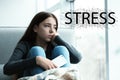 Word STRESS and depressed young girl sitting at window