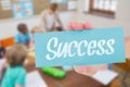 Success against pretty teacher helping pupils in classroom Royalty Free Stock Photo
