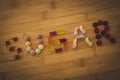 The word sugar spelled on a wooden plank with different kinds of colorful sweets.